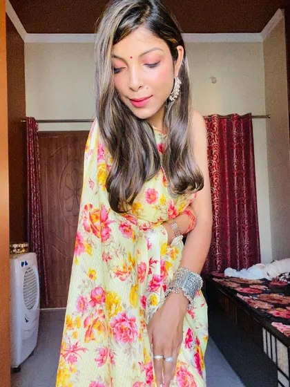A full-length view of the yellow floral saree. The lightweight fabric makes it easy to move in, proving that sarees can be both beautiful and practical for everyday wear.