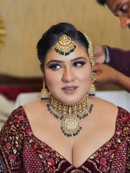 A candid moment of the bride getting ready. Even in between shots, the makeup looks perfect and the skin looks radiant.