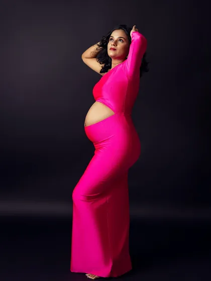 A powerful, statuesque pose that celebrates the strength and beauty of the pregnant form.