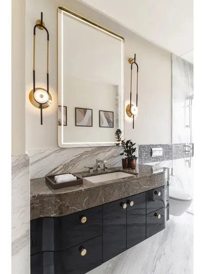 This duplicate image shows the same elegant bathroom design, highlighting the beautiful marble countertop and sophisticated lighting.