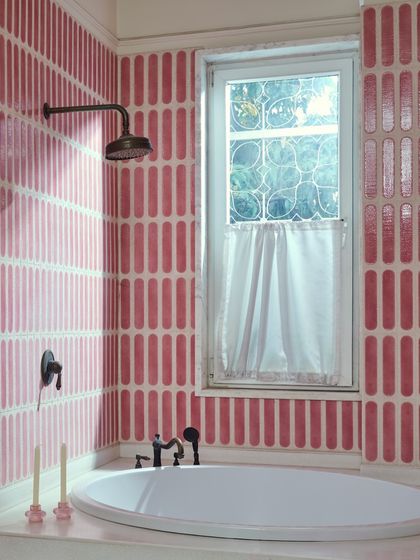 A view of the sunken tub in the mulberry bathroom. The rhythmic pattern of the tiles and the soft light from the window create a serene, spa-like atmosphere for this personal sanctuary.