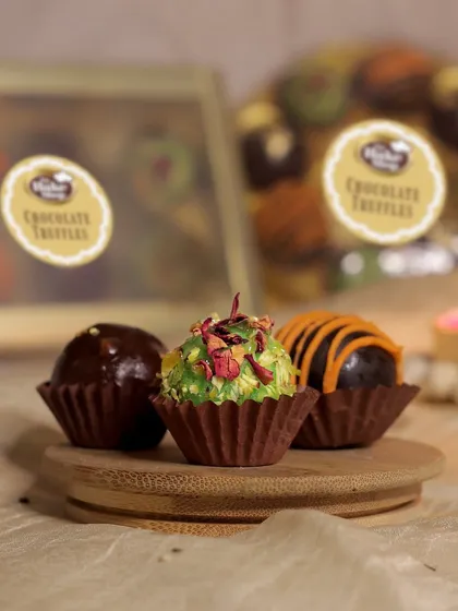 Our chocolate truffles are perfect for any celebration. This shot highlights three of our mouth-watering flavors: hazelnut, chocolate orange, and coconut rose.