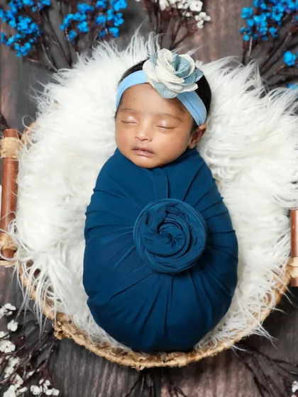 A daughter is a flower that fills the world with beauty. This baby girl is wrapped like a blue rose, looking so precious.