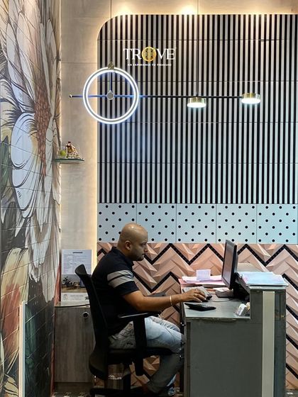 Our team is here to listen and help bring your ideas to life. This reception desk, backed by a creative mix of tile patterns, is where your personalized design journey begins.