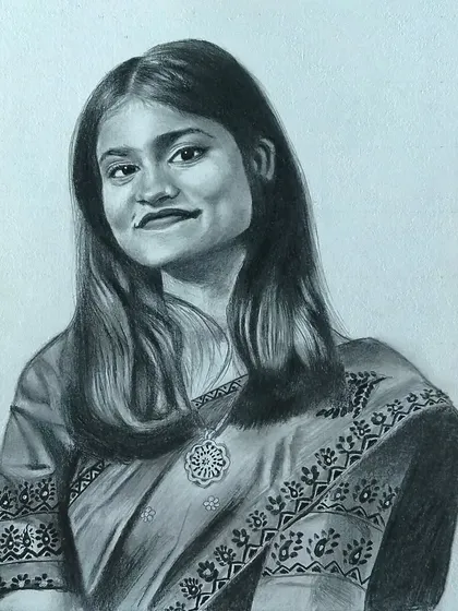 A portrait of a woman in a saree, showing the detailed patterns of her clothing.