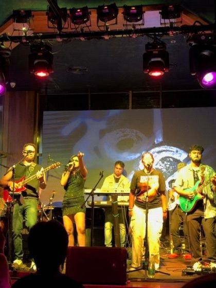 A photo from our show at Hard Rock Cafe in Chennai, with the iconic logo in the background. This reinforces our experience playing at well-known, respected venues.