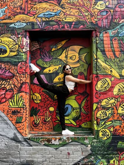 A throwback to a fun getaway in 2022. Posing in front of the vibrant and colorful graffiti walls in Toronto, Canada.