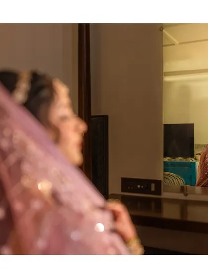 A beautiful shot of the bride looking in the mirror, capturing a moment of quiet reflection before she walks down the aisle.
