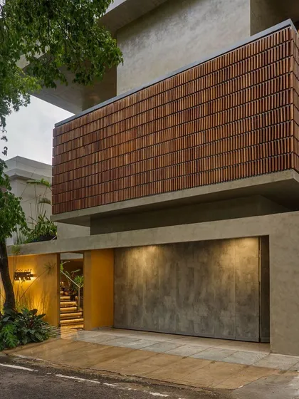 I love the honesty of raw materials. The facade of 'The Mantle' uses a combination of textured concrete and a warm wooden screen, creating a bold, modern statement that feels both strong and natural.