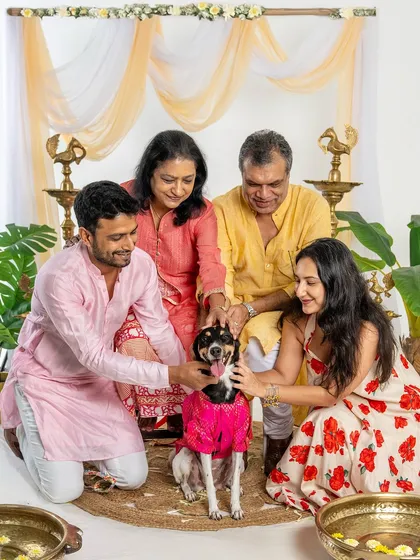 A loving family surrounds their dog during a festive Diwali shoot. This photo captures the warmth and togetherness of celebrating with every member of the family.