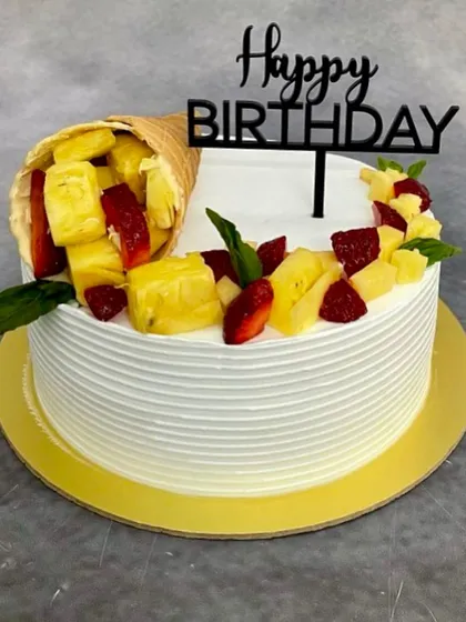 A variation of the gravity-defying cone cake, this time with fresh pineapple and strawberries for a tropical twist.