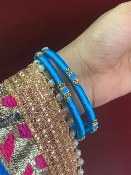 Explore my range of blue silk thread bangles, featuring different styles with kundan stones, coins, and pearl embellishments.