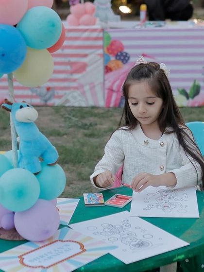 A young guest enjoying a coloring activity at a table set up specifically for kids' entertainment.