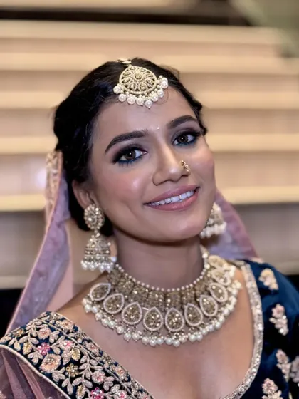 A bright, happy smile from this bride-to-be. The makeup is designed to look great in photos, with a focus on bright eyes and a radiant complexion.