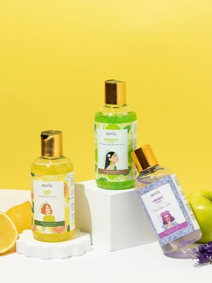 A vibrant group shot of three colorful body washes. We used white geometric blocks and fresh fruit ingredients to create a playful and energetic scene that showcases the different scents.