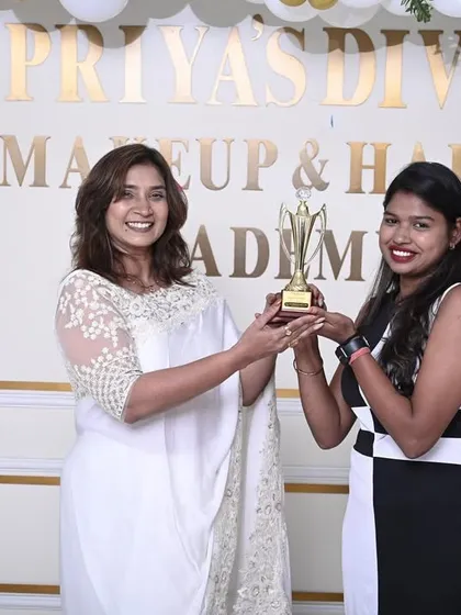 Awarding a trophy and certificate to a deserving student from Batch 13.