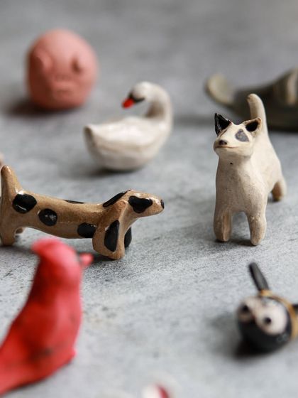 A collection of miniature animals, including a dachshund and a cat, showcasing the charming results of our beginner friendly workshop.