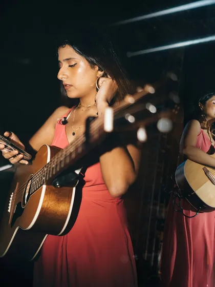 A candid moment on stage, getting ready for the next song. The energy of a large venue is palpable.