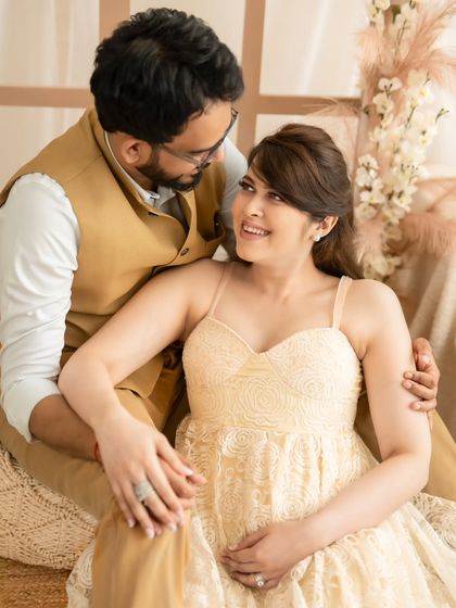 A beautiful, interactive portrait of a couple sharing a loving look in our warm, rustic studio setting.
