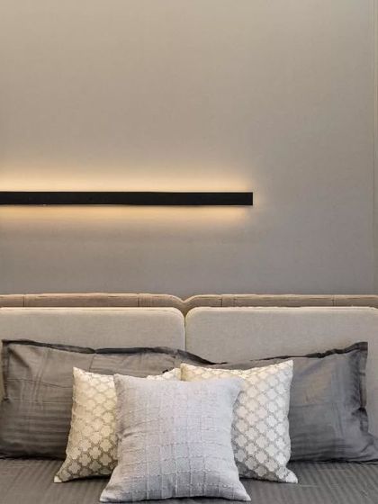 This detail of a linear Black Patti accent draws the eye, adding a sense of structured geometry to the soft, muted tones that dominate the space. The black "Patti" strategically positioned above the headboard serves as a sleek, minimalist focal point.