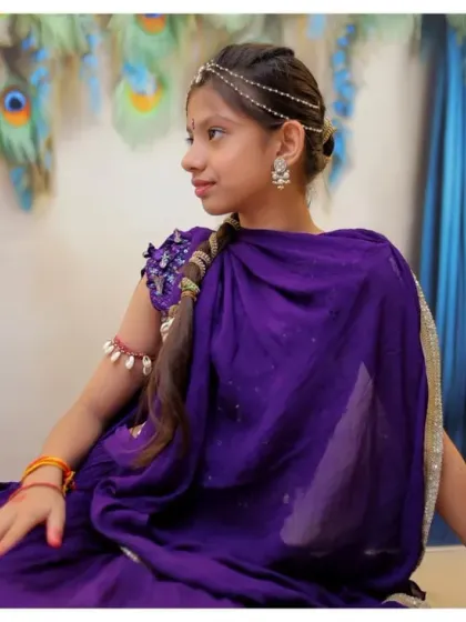 A lovely profile shot from a Radha-themed session, with soft lighting that enhances the traditional attire and accessories.