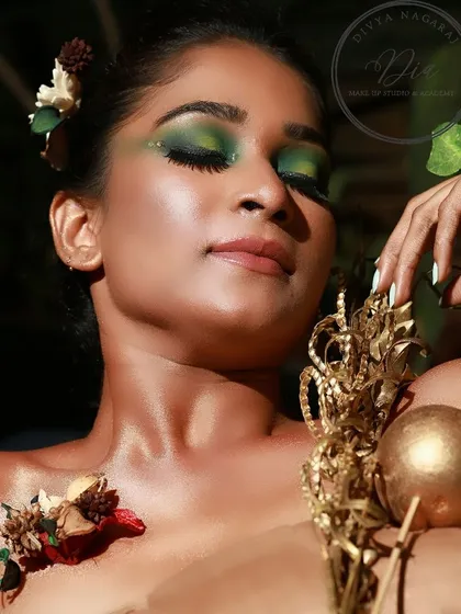 A close-up of the creative green eyeshadow look. You can see the detailed blending and the shimmering finish, which brings the whole artistic concept to life.