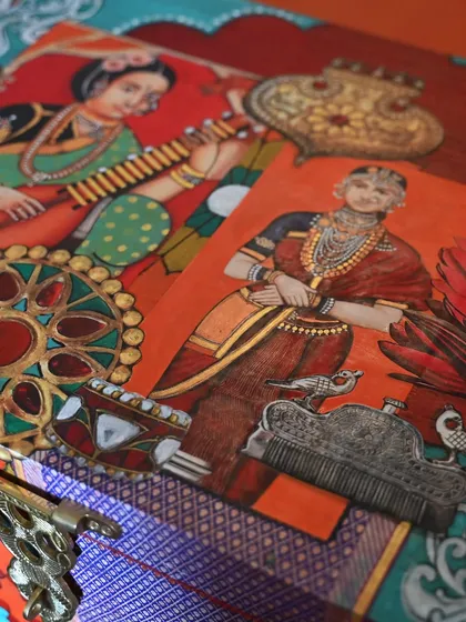 A detail shot revealing the layers of decoupage and hand-painting. This piece draws from reverse glass painting traditions, weaving together themes of fashion, jewelry, and objets d’art.