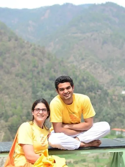 A throwback photo of two students from a past TTC, relaxing against the mountain backdrop. The course is intense, but there are also moments of rest and connection.