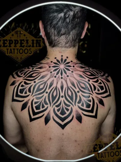 Large back pieces are a journey, and this finished geometric mandala is a testament to that process. I designed this to fit the client's entire upper back, using bold, solid blackwork to create a powerful and balanced piece that symbolizes harmony and wholeness.