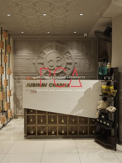 The main reception desk at the fashion studio, showcasing the blend of modern design with traditional carved elements.