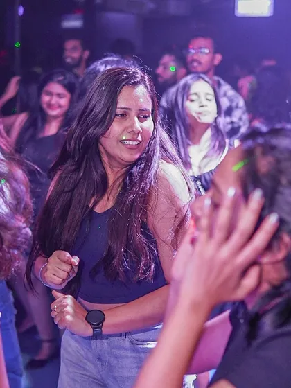 Friends dancing together, sharing the experience.