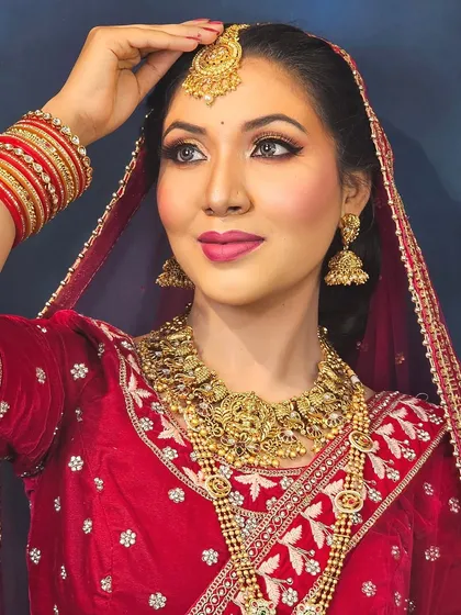A stunning South Indian bridal look featuring a temple jewelry set and a classic winged liner. The makeup is kept elegant to complement the heavy gold jewelry.