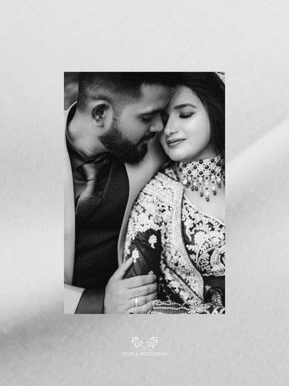 An intimate black and white portrait of the couple, capturing a tender and romantic embrace.