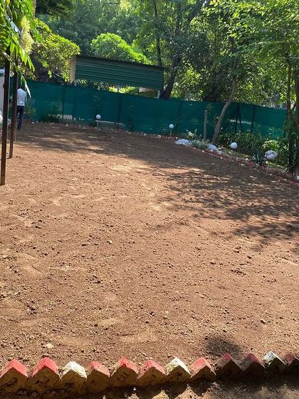 A residential garden area cleared and ready for soil preparation and grass installation.