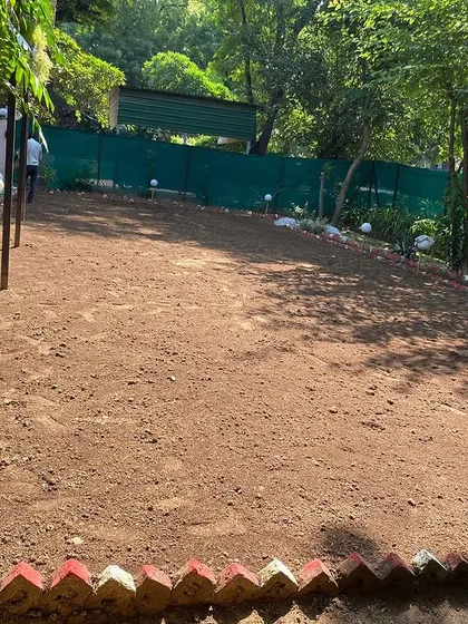 A residential garden area cleared and ready for soil preparation and grass installation.