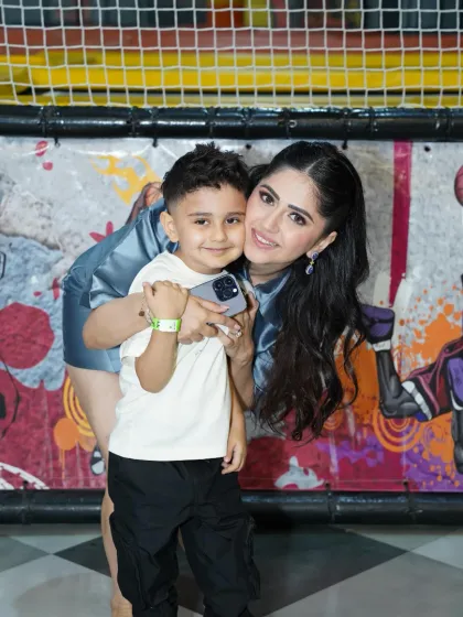 "Where little ones play and mommies slay!" A mother and son share a hug, perfectly capturing the spirit of our venue.