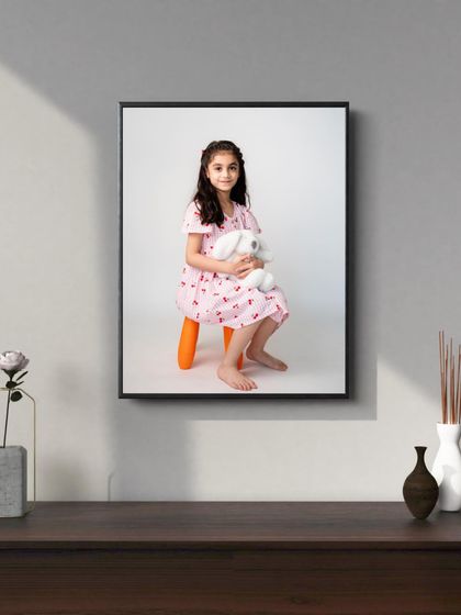 A simple, elegant portrait of an older child, framed as a standalone piece of art. My photography aims to create timeless images that you will be proud to display.