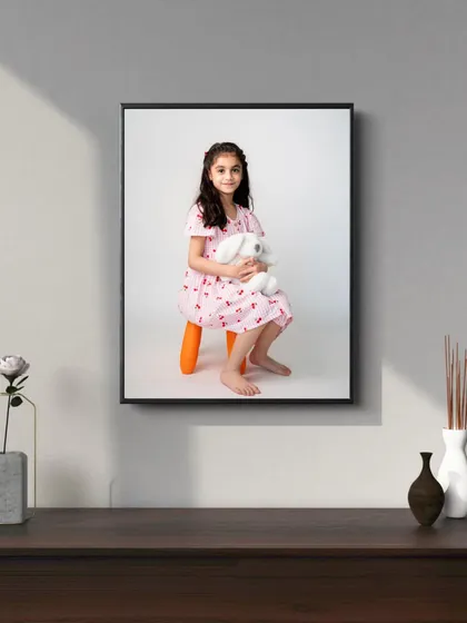 A solo portrait of your child is a wonderful way to capture their personality at a specific age. This framed print is a timeless keepsake that will be treasured as she grows.
