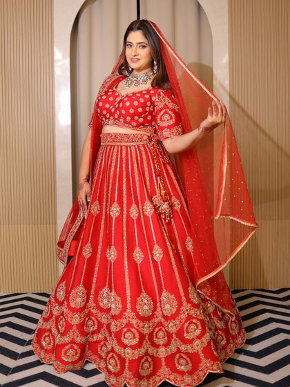 A plus-size model looking radiant in a classic red bridal lehenga. I believe every bride, regardless of her size, deserves to feel like a queen on her wedding day.