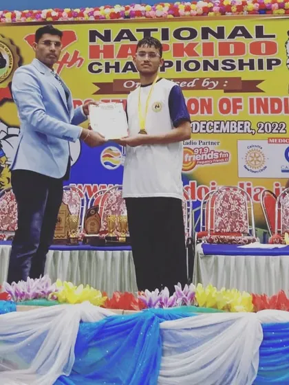 Vivek Mehra on the podium after winning a gold medal in Hapkido. He is a dedicated and powerful athlete.