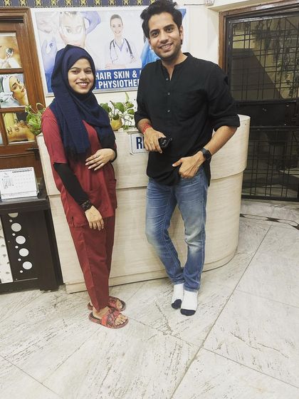 A full-length shot of our doctor with visitor Shivam Malik at our clinic's front desk. We are proud of the welcoming and professional environment we have created.