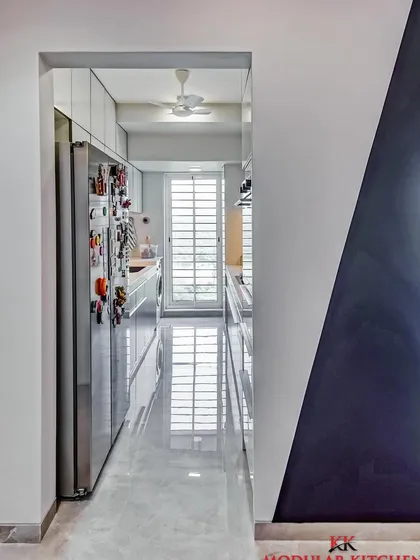 A view from the hallway into this sleek parallel kitchen, showing how our designs integrate seamlessly with the rest of the home.
