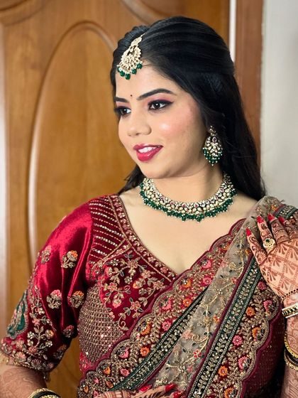 A happy bride showing off her reception look, complete with intricate henna and beautiful jewellery.