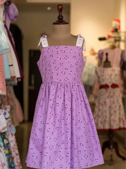 This lilac floral dress is perfect for a spring or summer day. The simple square neckline is accented with delicate lace on the straps for a sweet, charming finish.