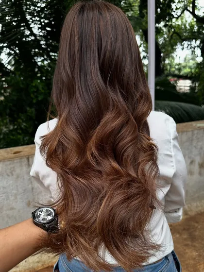 Getting ready for 'Ghar ki shaadi' (a home wedding). This client wanted a glamorous but natural look, so I gave her a rich color melt with soft waves, perfect for the occasion.