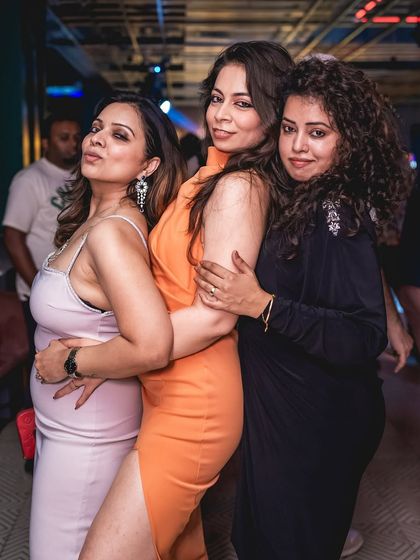 Posing with friends at Gawky Goose. My parties are a great place to connect with fellow music lovers.