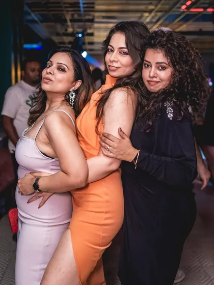 Posing with friends at Gawky Goose. My parties are a great place to connect with fellow music lovers.