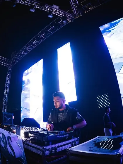 Focused in the zone. Here’s a look at me working the Pioneer decks, surrounded by a massive LED setup that transforms the venue.
