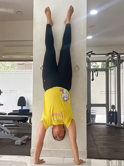 Turning the world upside down with a wall-assisted handstand. This is a great calisthenics exercise for building shoulder and core strength.
