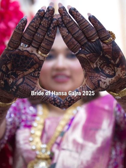 A creative pose by the bride, framing her face with her portrait mehendi. This shows how the art becomes a part of her and her story, even in playful moments.